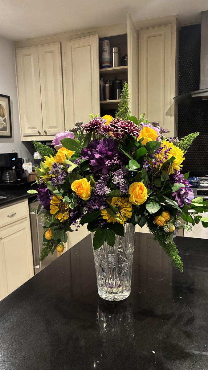 Golden roses and plum lisianthus in cut crystal
